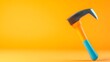 © Olivia - A vibrant orange and blue claw hammer rests on a matching orange background