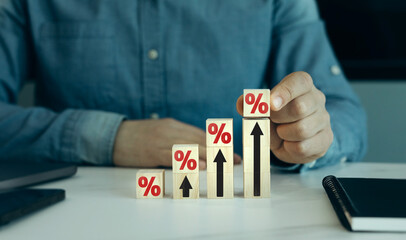 Aufkleber - Close-up hands with wooden block with percentage symbol and up arrow.Interest rate and dividend. Percentage interest rates continue to increase, stocks and mutual funds, investment for retirement.