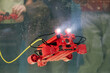 © Seventyfour - Robotic gadget being tested underwater with lights illuminating surroundings. Yellow cable attached to device for power supply and control, showcasing robotics technology