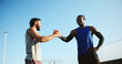 © peopleimages.com - Happy men, fitness and city with handshake for teamwork, meeting or greeting together. Active, male people or friends shaking hands with smile for workout, exercise or training in an urban town
