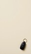 © ศักดิ์สิทธิ์ หวังคู่ - A set of car keys with a black fob and metal sits on a cream colored background, creating a minimalist and modern aesthetic with ample copy space around it.