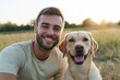 © Andrii Zastrozhnov - A man and his dog are smiling and posing for a picture. The man is wearing a white shirt and the dog is a golden retriever. Scene is happy and friendly