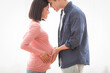 © Prostock-studio - Pregnancy Happiness. Loving Asian Couple Waiting For Baby, Young Husband Touching Pregnant Wife's Belly Posing Standing Near Window At Home. Cute Family Moments, Parents-To-Be. Side View, Copy Space