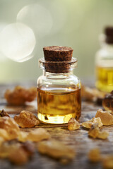 Wall Mural - A bottle of frankincense essential oil with frankincense resin