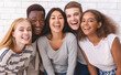 © Prostock-studio - Portrait of happy multiethnic young friends students having fun over white wall background, close up
