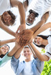 © Prostock-studio - Friends Unity. Low Angle Portrait Of Happy Teenage People Stacking Hands Together And Smiling At Camera, Showing Teamwork And Cooperation