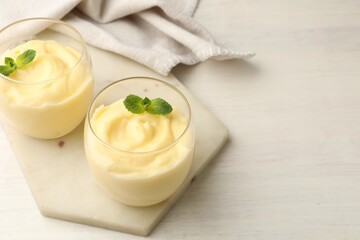 Wall Mural - tasty vanilla pudding with mint on white wooden table. space for text