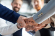© Prostock-studio - Cropped of a business teams hands clasped together in a fist bump, showcasing their camaraderie and unity. The image captures the essence of teamwork and collaboration in a professional setting.