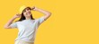© Pixel-Shot - Happy young woman in bucket hat on yellow background with space for text