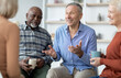 © Prostock-studio - Multiethnic elderly people attending group therapy session at nursing house, positive senior man and woman sitting in circle, drinking tea and having conversation with psychologist, closeup