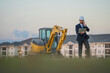 © Olena - Buider man in suit and hardhat. Construction investor. Business man investor in front of construction site. Successful investor. Handsome man in suit and hardhat at building construction.