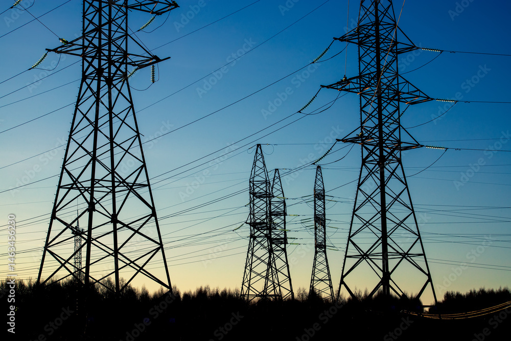 Looking up steel power pylon construction with high voltage cables ...
