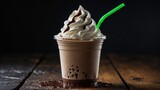 Takeaway mocha frappuccino with cream served in disposable cup on wooden table against black background