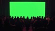 © Thanaporn - a raw of sitting audience from the back, green screen background, men and women sitting in a raw, back view