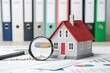 © Mobasser - Real estate market analysis: house model with magnifying glass and financial charts
