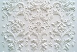 Intricate embossed white plaster floral arabesque pattern wallpaper background