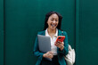 © Westend61 - Businesswoman smiling while using smartphone outdoors