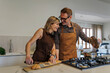 © Westend61 - Couple cooking together in a modern kitchen, smiling and preparing a meal