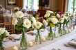 © wpw - elegant wedding table arrangement with cotton flowers in recycled glass bottles as part of eco decor.