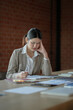 © mojo_cp - Tired asian business woman overworking and headache stressed in office