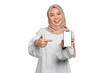 © Sewupari Studio - Excited young Asian Muslim woman showing mobile phone blank screen recommending App isolated on transparent background