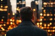 © Hox - Man facing city lights