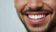 © Aliona - A close-up of a smiling man showcases his well-groomed beard and strikingly white teeth, exuding confidence and friendliness.