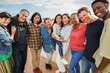 © DisobeyArt - Group of multigenerational friends smiling in front of camera - Multiracial people of different ages having fun together - Main focus on center faces