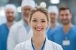 © Jibber  - Lächelnde Ärztin im Vordergrund mit medizinischem Team im Krankenhaus
