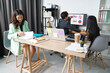 © DG PhotoStock - A group of Asian employees are working and brainstorming together in a small startup home office.