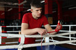 © New Africa - Man wrapping her hands on boxing ring
