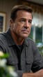 © GenMotion - Portrait of a mature man indoors thoughtful expression wearing a casual shirt jacket in a domestic scene natural light