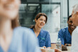 © Maskot - Mature medical worker talking with colleagues in cafeteria at hospital