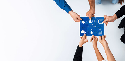 Fototapete - Hands gather around a blue paper featuring communication and analytics icons, symbolizing teamwork in marketing strategy development and innovative business solutions. Amity