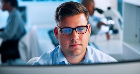 Poster - Computer, healthcare and man with glasses in lab for online research, analysis and medical report. Reading, administration and person on pc for planning experiment, pharmaceutical study and results