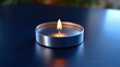 © Julia - A dark space is illuminated by a peaceful candle, which has a soft flame and creates a serene ambiance