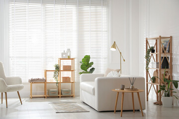 Poster - Stylish shelving unit with decor and sofa in room