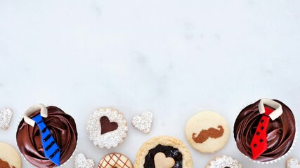 Leinwandbilder - Fathers Day variety of tasty sweet desserts. Overhead view, stop motion, bottom border over a white marble background.