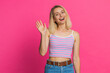 © Andrii Iemelianenko - Hello. Young Caucasian woman smiling friendly at camera, waving hands gesturing hi greeting or goodbye welcoming with invitation hospitable expression. Pretty girl isolated on pink studio background