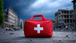 © SAN - A red first aid kit sits in the foreground amidst a devastated city after an earthquake event.