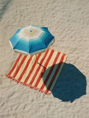 Poster - Colorful Beach Umbrella Casting Shadow on Striped Towel on Sandy Shore During Sunny Day Generative AI