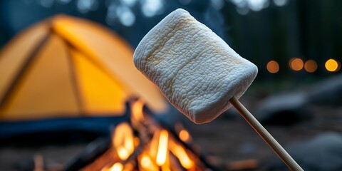 Wall Mural - Toasted marshmallow on stick by campfire near orange tent in forest setting