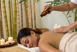 Soothing back massage with warm aromatic oil in tranquil bamboo spa room, relaxing atmosphere with candles and gentle touch