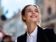 © TAO - Confident beautiful young woman in professional attire, standing outdoors smiling and looking up at the sky. Great for advertising and branding.