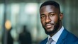 © sogap - A Confident Young African Man in a Suit Looks Directly at the Camera with a Calm and Friendly Expression Outside