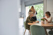 © Marc Elias - Coworkers chatting and drinking coffee during a break in the office kitchen