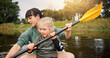© peopleimages.com - Lake, child and woman with teaching for kayak, water activity and adventure in summer camp. River, female instructor and girl with learning for canoeing, skills development and paddle outdoor in boat