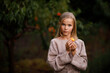 © Татьяна Швец - Beautiful happy girl in brown dress in peach garden in summer at sunset