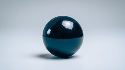 Poster - A polished obsidian sphere sits elegantly on a subtly illuminated surface, highlighting its reflective curves against a minimalistic gray backdrop