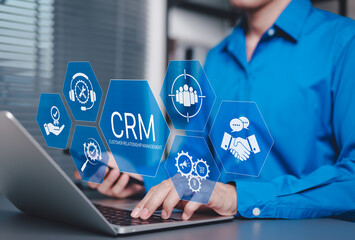 Wall Mural - CRM Customer Relationship Management Concept. Businessman using laptop with CRM icons representing customer support, service, relationship building, sales, and marketing automation tools software.